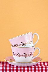 Image showing Two retro style teacups on gingham cloth