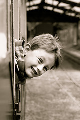 Image showing Little boy leaning out of a train window