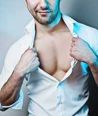 Image showing Sexy Male Model Unbuttoning His White Shirt