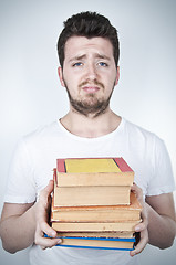 Image showing Sad student holding books