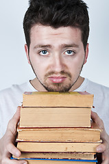 Image showing Young man holding books