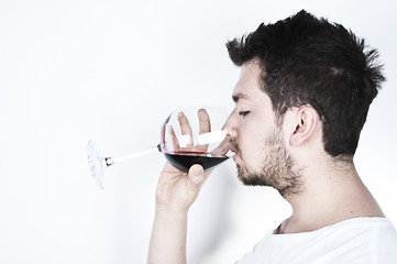 Image showing Young man drinking wine