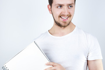 Image showing Blonde Male Holding a Notebook