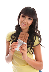 Image showing Pretty young woman eating chocolate