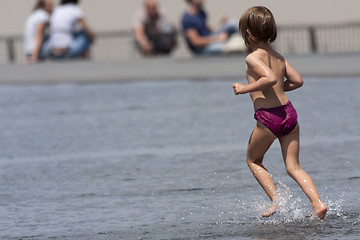 Image showing Child running in the water.