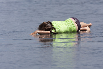Image showing Child lying in the water. 