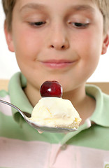 Image showing Boy with ice cream and cherry on top