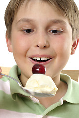 Image showing Smiling boy holding large scoop of ice cream