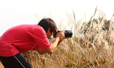 Image showing photographer taking photo in country side 