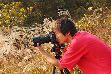 Image showing photographer taking photo in country side 