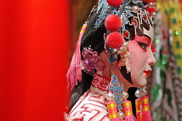 Image showing chinese opera dummy and red cloth as text space ,it is a toy,not