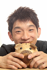 Image showing asia man with piggy bank 