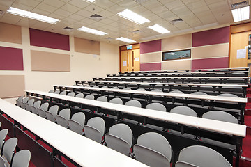 Image showing Empty hall for presentation with grey armchairs 