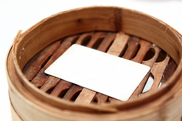 Image showing White card in chinese bamboo steamer 