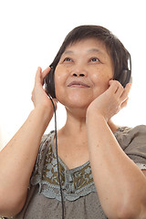 Image showing Senior woman listening to music with headphones 