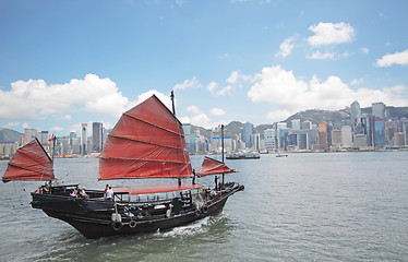 Image showing Junk boat with tourists in Hong Kong Victoria Harbour