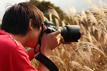 Image showing photographer taking photo in country side 