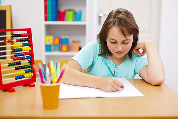 Image showing Teen girl practicing and doing homework