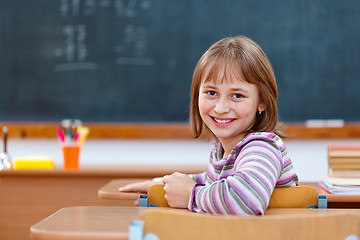 Image showing Elementary school girl turning back and smiling