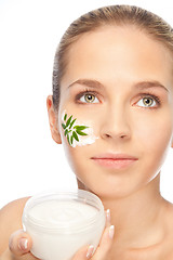 Image showing Beautiful women applying moisturizer cosmetic cream