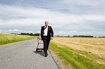 Image showing Businessman and his Lawn mower