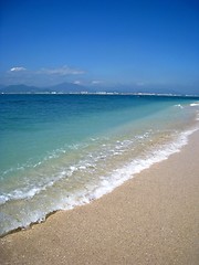 Image showing Water rolling in over a sandy beach