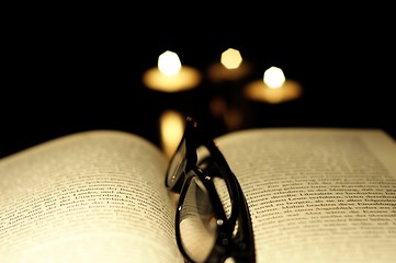 Image showing book candle and glasses