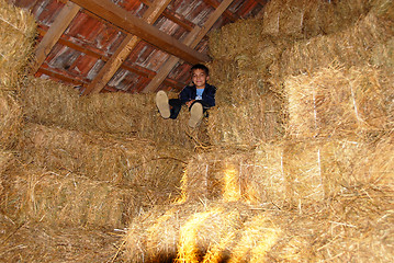 Image showing Boy on straw bales