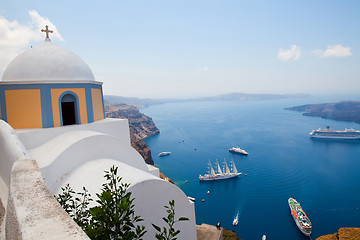 Image showing Old church dome and view of boats in Santorini