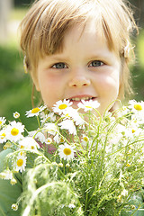 Image showing Little girl with daisies