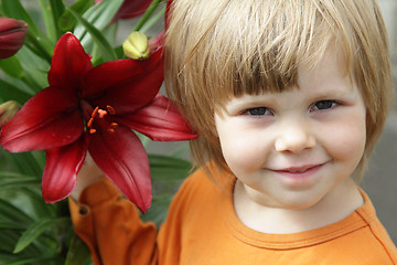 Image showing Little girl with a lily