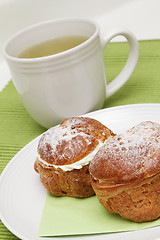 Image showing Two profiteroles and tea