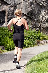 Image showing fat woman running around in the park