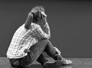 Image showing Offended by a girl sitting on the floor