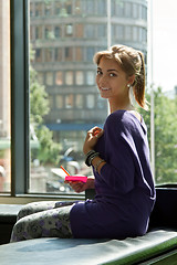 Image showing beautiful girl sitting by the window