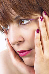 Image showing Young woman holding her face