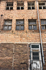Image showing Angle shot of an abandoned industrial building with brick wall