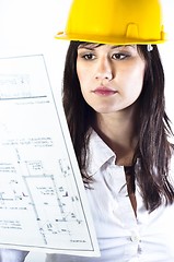 Image showing Engineer woman in yellow helmet with plans