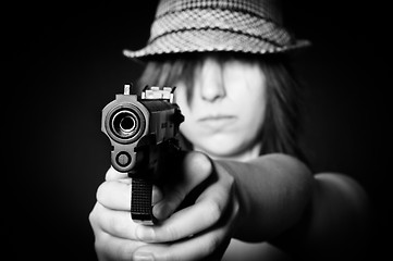 Image showing Girl in hat with a big pistol