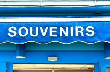 Image showing souvenirs sign on wet blue surface