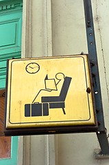 Image showing Sit and wait sign in a train station