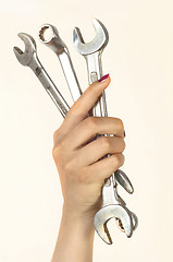 Image showing woman holding big chrome vanadium spanners in the hand