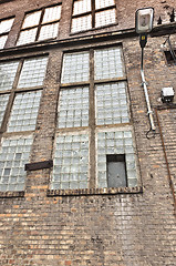 Image showing Angle shot of an abandoned industrial building with brick wall