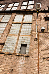 Image showing Angle shot of an abandoned industrial building with brick wall