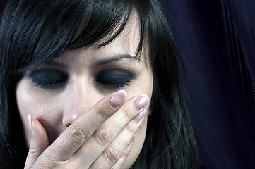 Image showing Young girl covering her mouth with her hand in black and white