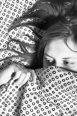 Image showing Girl scared of something under blanket