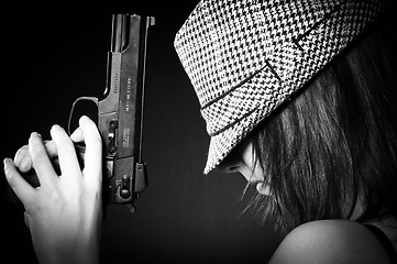 Image showing Girl in hat with a big pistol