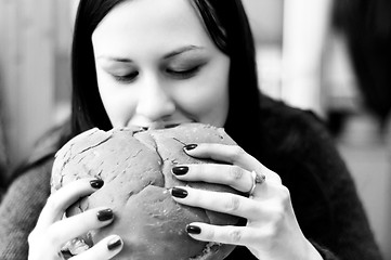 Image showing Young woman eating hamburger