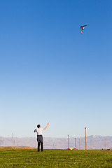 Image showing man flying a kite