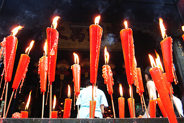 Image showing Joss sticks and candles burning at a temple